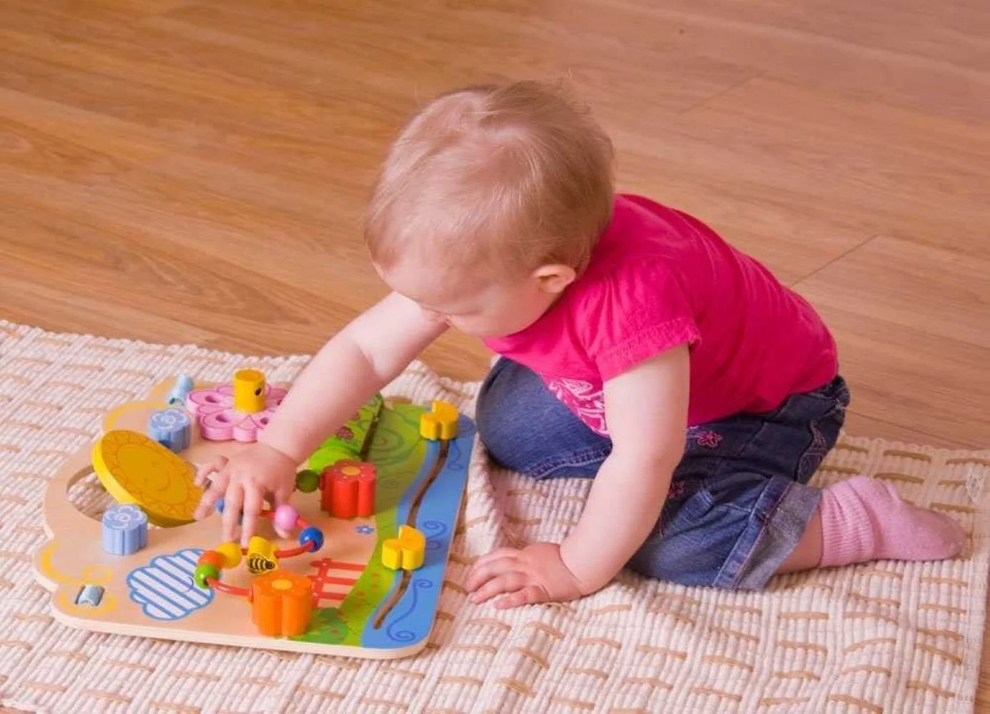 Bigjigs Toys Dřevěná motorická deska květy
